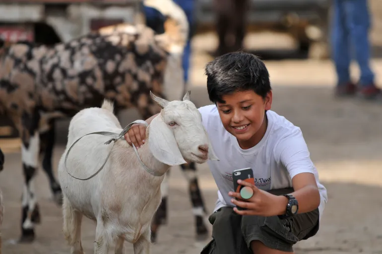 A boy takes selfie with the goast after buying for the Bakra Eid or Eid al-Adha or Id-ul-Azha on Sunday, August 11, 2019 in Kathmandu, Nepal. Bakra Eid, also known Eid al-Adha or Id-ul-Azha in Arabic, is a 'Feast of Sacrifice' and celebrated as the time to give and to sacrifice. Nepalese goverment announced a public holiday on the occasion of Bakra Eid or Eid al-Adha or Id-ul-Azha, one of the two major festivals for Muslims worldwide. (Photo by Narayan Maharjan/NurPhoto via Getty Images)